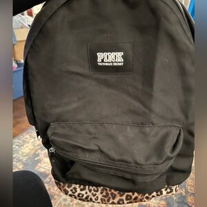 Pink leopard and black backpack